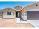 Inviting single-story home featuring a two-car garage, desert landscaping, and neutral color palette at 21916 W Duane Ln, Wittmann, AZ 85361