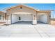 Spacious two-car garage with white walls and concrete floors, illuminated by natural light at 21916 W Duane Ln, Wittmann, AZ 85361