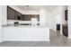 Kitchen with granite countertops, dark wood cabinetry, and stainless steel appliances at 21916 W Duane Ln, Wittmann, AZ 85361