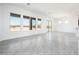 Bright open-concept living area featuring gray tile flooring, white walls, and expansive windows at 21916 W Duane Ln, Wittmann, AZ 85361