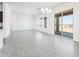 Bright living space with natural light, grey tiled floors, and access to the backyard at 21916 W Duane Ln, Wittmann, AZ 85361