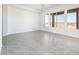 Open living space with large windows and grey tiled floors at 21916 W Duane Ln, Wittmann, AZ 85361
