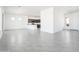 Bright living room with grey tiled floors that opens up into the kitchen at 21916 W Duane Ln, Wittmann, AZ 85361