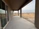 Covered patio with a view of the backyard and sliding glass doors leading indoors at 21916 W Duane Ln, Wittmann, AZ 85361