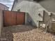 Gravel backyard with access gate, utility boxes, and meter at 2441 W Beverly Rd, Phoenix, AZ 85041