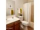 Cozy bathroom featuring a vanity with wood cabinetry, toilet, and shower at 2441 W Beverly Rd, Phoenix, AZ 85041