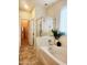 Bright bathroom features a separate tub and shower, and tile flooring at 2441 W Beverly Rd, Phoenix, AZ 85041