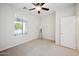 Simple bedroom with window, ceiling fan, and neutral decor at 2441 W Beverly Rd, Phoenix, AZ 85041