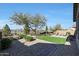 Landscaped backyard with artificial turf and lake view at 24454 N 173Rd Ln, Surprise, AZ 85387