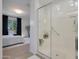 Modern bathroom with a glass-enclosed shower and an adjacent bedroom at 24454 N 173Rd Ln, Surprise, AZ 85387