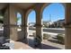 Covered front porch with arched entryway and view of neighborhood at 24454 N 173Rd Ln, Surprise, AZ 85387