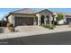 Single-story house with arched entryway and landscaped yard at 24454 N 173Rd Ln, Surprise, AZ 85387