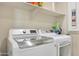 Laundry room with washer, dryer, and overhead shelving at 24454 N 173Rd Ln, Surprise, AZ 85387