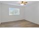 Simple bedroom with wood-look floors and window coverings at 2543 E Manhatton Dr, Tempe, AZ 85282