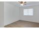 Simple bedroom with wood-look floors and ceiling fan at 2543 E Manhatton Dr, Tempe, AZ 85282