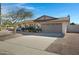 Front view of the house showcasing a large driveway and landscaping at 2543 E Manhatton Dr, Tempe, AZ 85282