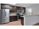 Modern kitchen with dark cabinetry, stainless steel appliances, and granite countertops at 2543 E Manhatton Dr, Tempe, AZ 85282