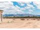Backyard featuring desert landscaping and distant mountain views at 25519 W Brookhart Way, Wittmann, AZ 85361