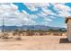 Distant mountains can be seen from the backyard that has desert landscaping at 25519 W Brookhart Way, Wittmann, AZ 85361