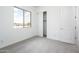 Clean bedroom featuring carpet flooring and large closet at 25519 W Brookhart Way, Wittmann, AZ 85361