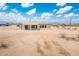 Back exterior of home featuring a covered patio and a view of the large, open lot at 25519 W Brookhart Way, Wittmann, AZ 85361