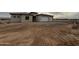 A single-story stucco home with a two car garage and desert landscaping at 25519 W Brookhart Way, Wittmann, AZ 85361