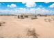 Exterior of home featuring a covered patio and a view of the large, open lot at 25519 W Brookhart Way, Wittmann, AZ 85361