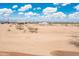 Home exterior showcasing the expansive lot with desert landscaping and a neighboring property at 25519 W Brookhart Way, Wittmann, AZ 85361