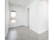 Bright and spacious foyer with neutral tones, light gray flooring, and a welcoming front door at 25519 W Brookhart Way, Wittmann, AZ 85361