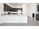 Kitchen with a granite island and stainless steel appliances at 25519 W Brookhart Way, Wittmann, AZ 85361