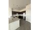 Open kitchen featuring granite countertops, dark wood cabinetry and gray tile floors at 25519 W Brookhart Way, Wittmann, AZ 85361