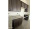 A kitchen featuring granite countertops and dark wood cabinetry at 25519 W Brookhart Way, Wittmann, AZ 85361