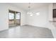 Open living area with a slider glass door and eat-in kitchen at 25519 W Brookhart Way, Wittmann, AZ 85361