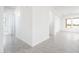 Bright and spacious living room with neutral tones, light gray flooring, and large windows at 25519 W Brookhart Way, Wittmann, AZ 85361