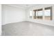 Bright and spacious living room with neutral tones, light gray flooring, and large windows at 25519 W Brookhart Way, Wittmann, AZ 85361