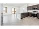 Open living and kitchen area with sliding glass door and stainless appliances at 25519 W Brookhart Way, Wittmann, AZ 85361