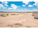 Expansive yard with desert landscape features a view of a distant community at 25519 W Brookhart Way, Wittmann, AZ 85361