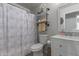 Clean bathroom, shower/tub combo, white vanity, and shelving at 2602 W Roeser Rd, Phoenix, AZ 85041