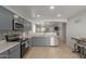 Modern kitchen with gray cabinets, stainless steel appliances, and an open design at 2602 W Roeser Rd, Phoenix, AZ 85041