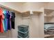 Organized closet with hanging clothes and storage bins at 2629 E Santa Maria Dr, Casa Grande, AZ 85194