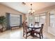 Cozy dining area with wood table and chairs near a window at 2629 E Santa Maria Dr, Casa Grande, AZ 85194