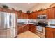 Modern kitchen with stainless steel appliances and wood cabinets at 2629 E Santa Maria Dr, Casa Grande, AZ 85194