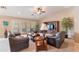 Living room with leather furniture, a large TV, and lots of natural light at 2629 E Santa Maria Dr, Casa Grande, AZ 85194