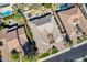 Overhead view of a house with a unique roofline, surrounded by other homes and a pool at 2952 E Warbler Rd, Gilbert, AZ 85297