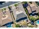 Overhead view of a house with a unique roofline, surrounded by other homes and a pool at 2952 E Warbler Rd, Gilbert, AZ 85297