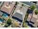 Overhead view of a house with a unique roofline, surrounded by other homes and a pool at 2952 E Warbler Rd, Gilbert, AZ 85297