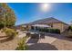 Relaxing backyard with patio furniture under an umbrella at 2952 E Warbler Rd, Gilbert, AZ 85297