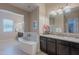 Elegant bathroom with a large soaking tub and double vanity at 2952 E Warbler Rd, Gilbert, AZ 85297