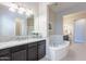 Spa-like bathroom featuring a soaking tub and granite countertops at 2952 E Warbler Rd, Gilbert, AZ 85297