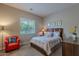 Cozy bedroom with a comfortable bed, armchair and ample natural light at 2952 E Warbler Rd, Gilbert, AZ 85297